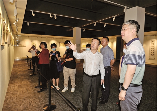 深圳市残联党组成员、副理事长尹葵（右三）与羊城晚报报业集团专职编委胡泉（右）观展.jpg