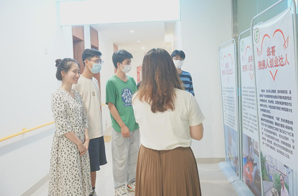 图为黄社工向实践队员介绍就业创业成功的残疾人典范 通讯员 郑瑞基 摄.jpg