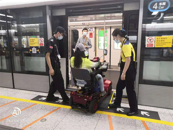 地铁工作人员助力残疾人上地铁