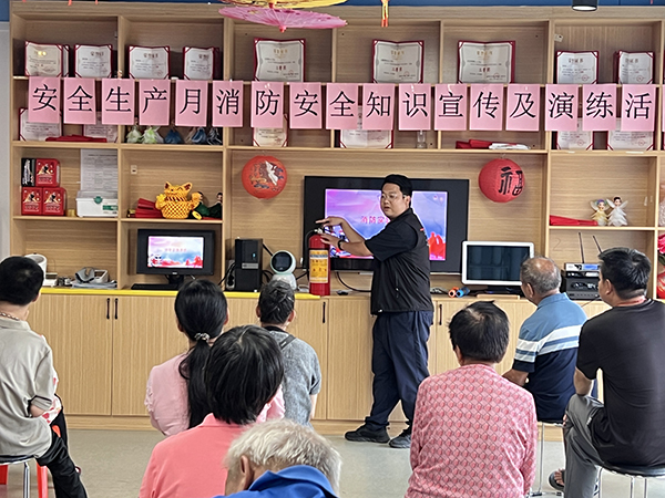 图：公明社区消防应急人员讲解灭火器使用方法
